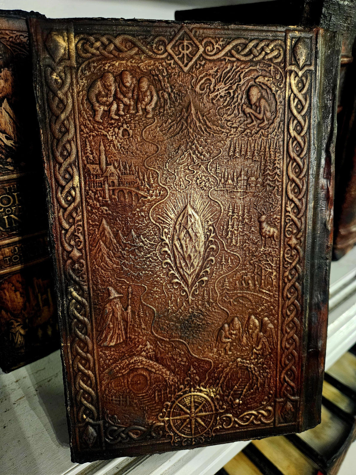 Actual illustrated journey-map rear relief, fine lines and decorations retained exactly. — original photograph, binding example